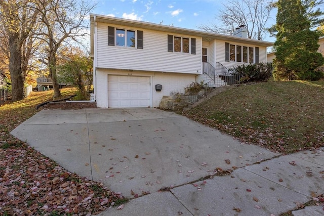 view of front of property with a garage and a front lawn