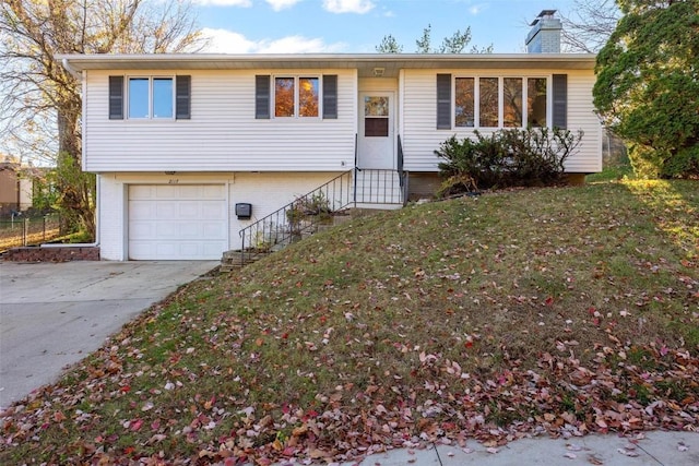 split foyer home with a front yard and a garage