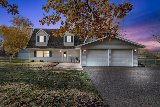 view of front of home featuring a lawn and a garage