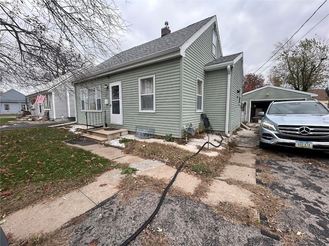 view of front of property with a garage and an outdoor structure