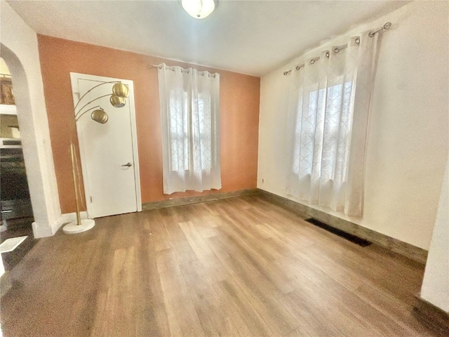 empty room with hardwood / wood-style floors