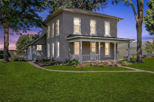 view of front of home with a lawn and covered porch