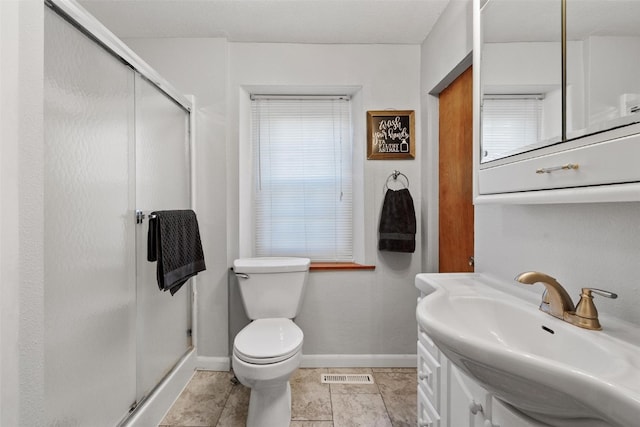 bathroom featuring tile patterned floors, vanity, toilet, and an enclosed shower