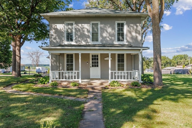 view of front facade featuring a front yard and covered porch