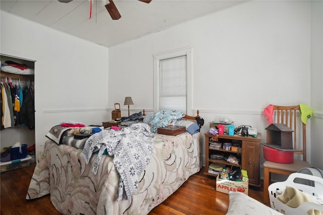 bedroom featuring ceiling fan, a closet, and dark hardwood / wood-style flooring