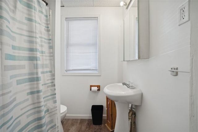 bathroom with toilet, a textured ceiling, hardwood / wood-style flooring, and a shower with shower curtain