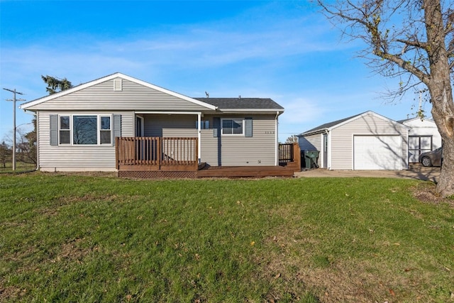 rear view of property featuring a garage, a yard, an outdoor structure, and a deck