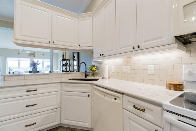 kitchen featuring sink, tasteful backsplash, white dishwasher, white cabinets, and range