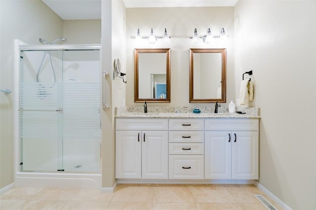 bathroom with tile patterned flooring, vanity, and a shower with shower door