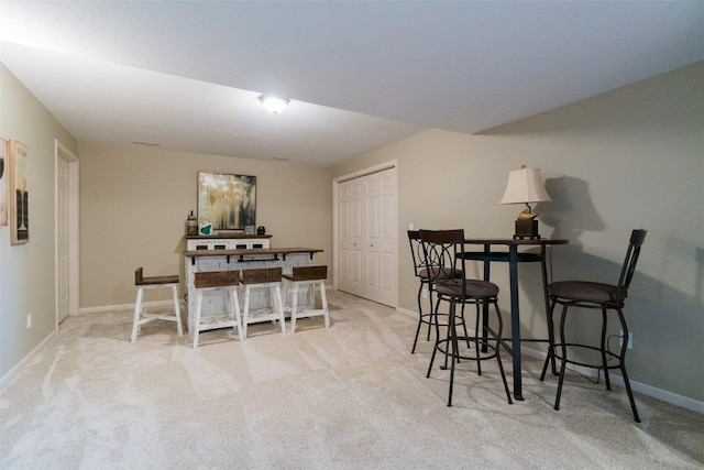 dining room featuring light carpet