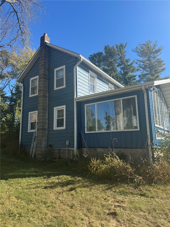 view of home's exterior featuring a yard