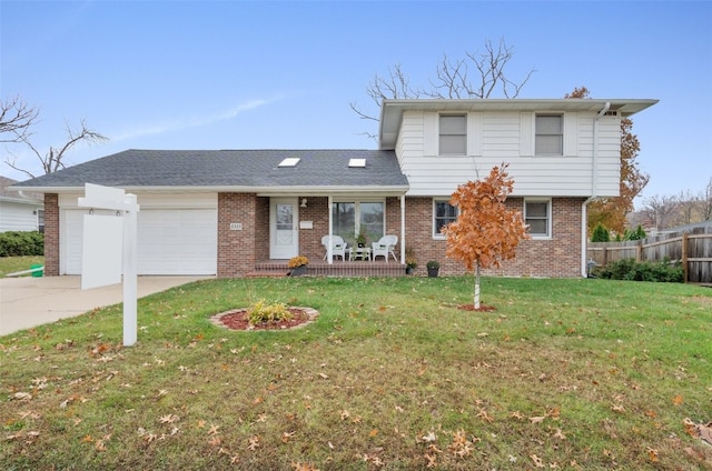 view of front of house featuring a garage and a front lawn