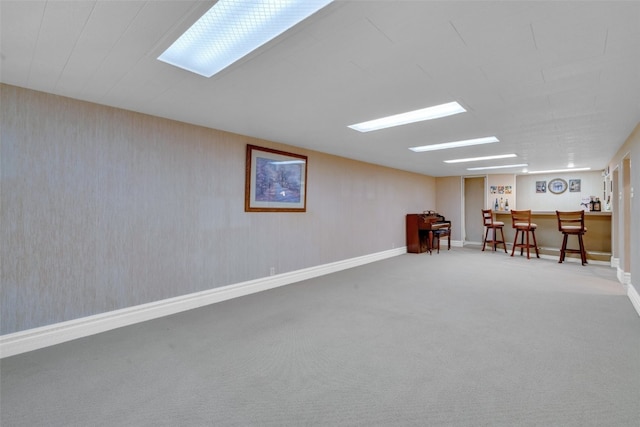 basement featuring bar area and carpet