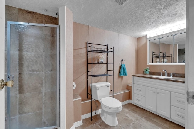 bathroom with tile patterned flooring, a textured ceiling, toilet, vanity, and a shower with shower door