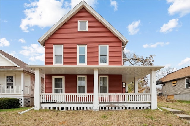 view of front facade with a front lawn and a porch