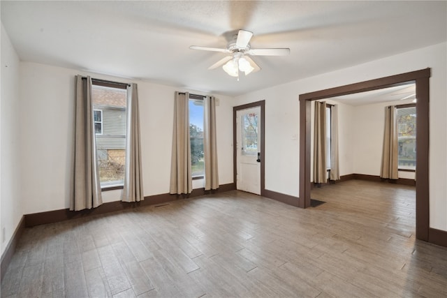 unfurnished room with hardwood / wood-style floors and ceiling fan