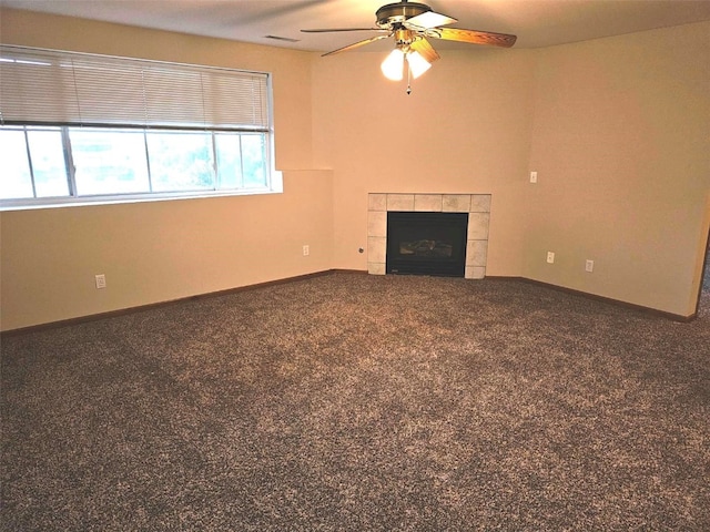 unfurnished living room with a fireplace, carpet flooring, and ceiling fan