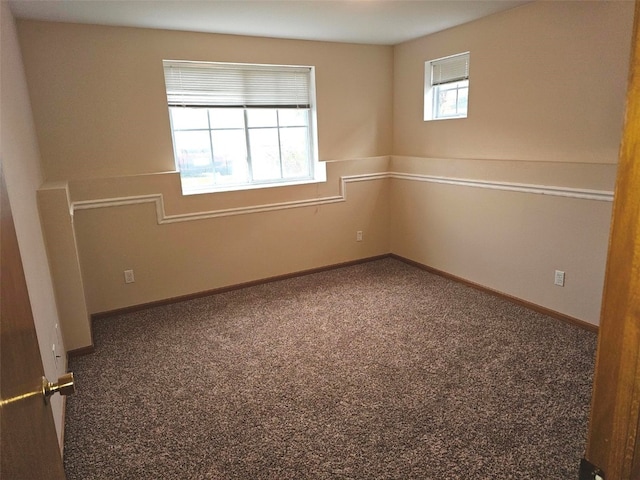 empty room featuring carpet flooring and a healthy amount of sunlight