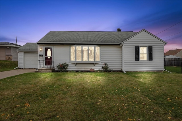 view of front of house with a lawn and a garage