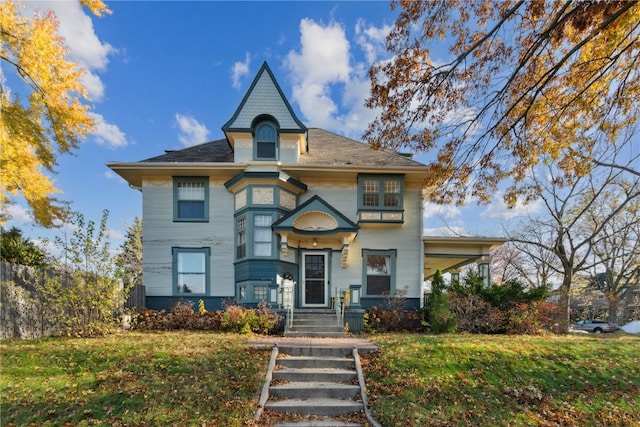 victorian home featuring a front yard