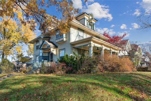 view of side of home with a yard