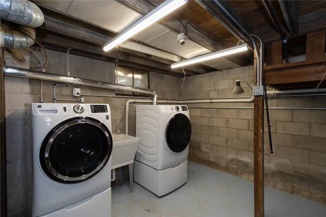 clothes washing area with washing machine and clothes dryer