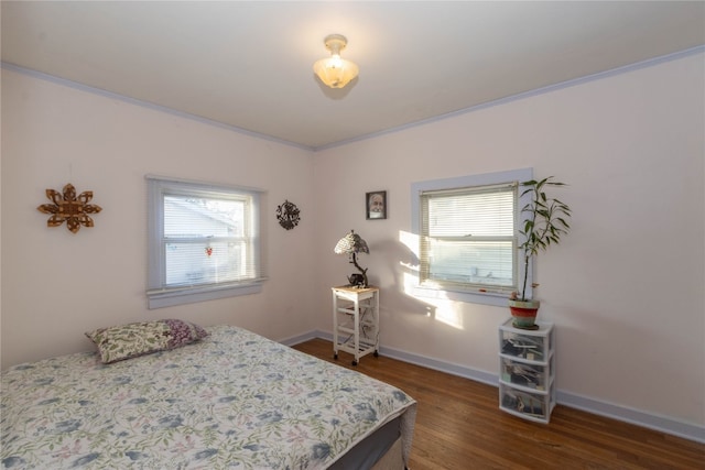 bedroom featuring ornamental molding and dark wood-type flooring