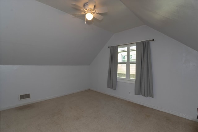 additional living space with ceiling fan, lofted ceiling, and light carpet