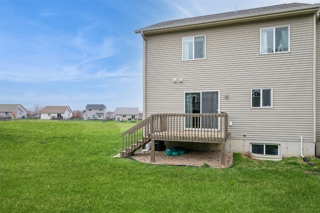 rear view of property featuring a deck and a yard