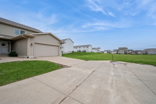 view of home's exterior featuring a yard and a garage