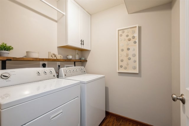 washroom featuring cabinets, independent washer and dryer, and dark wood-type flooring