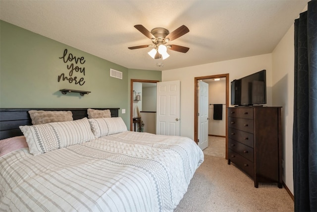 carpeted bedroom with ceiling fan and a textured ceiling