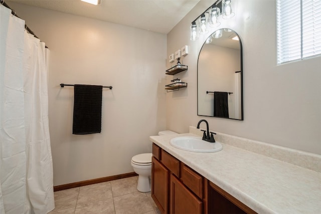 bathroom featuring toilet, vanity, and tile patterned floors