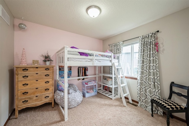 carpeted bedroom with a textured ceiling