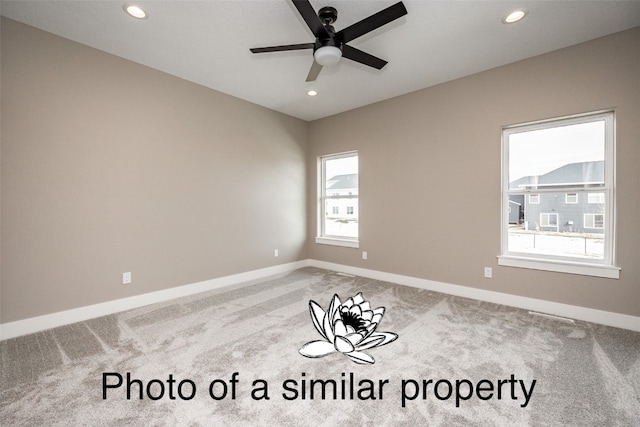 empty room featuring carpet flooring and ceiling fan