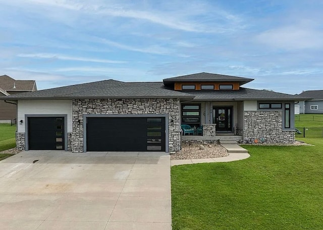 prairie-style house with a garage and a front lawn