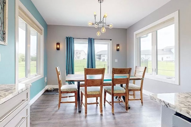 dining room featuring light hardwood / wood-style floors and an inviting chandelier