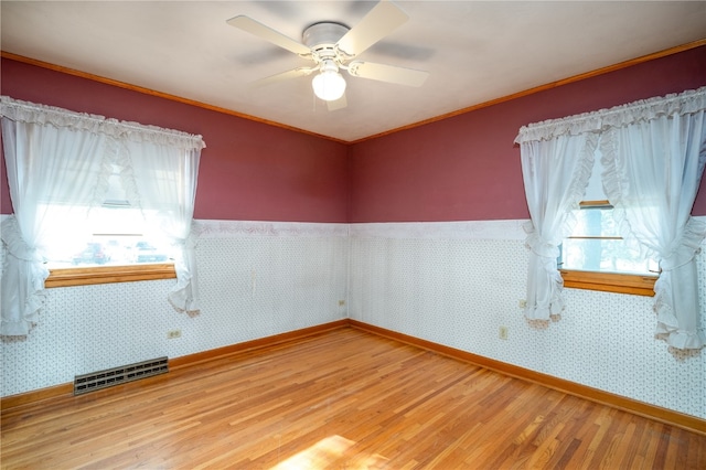 spare room featuring hardwood / wood-style floors and ceiling fan