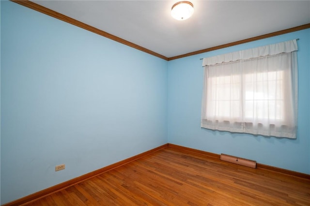 2482 65th St, Vinton, IA 52349 - unfurnished room with baseboards, crown molding, and wood finished floors