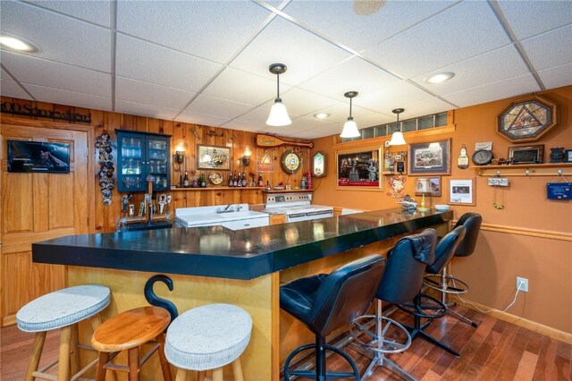 2482 65th St, Vinton, IA 52349 - indoor bar with white range with electric cooktop, a paneled ceiling, wood finished floors, baseboards, and hanging light fixtures