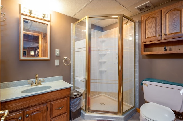 bathroom featuring vanity, toilet, and a shower with shower door