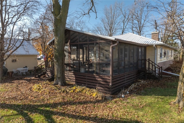 view of home's exterior featuring a sunroom