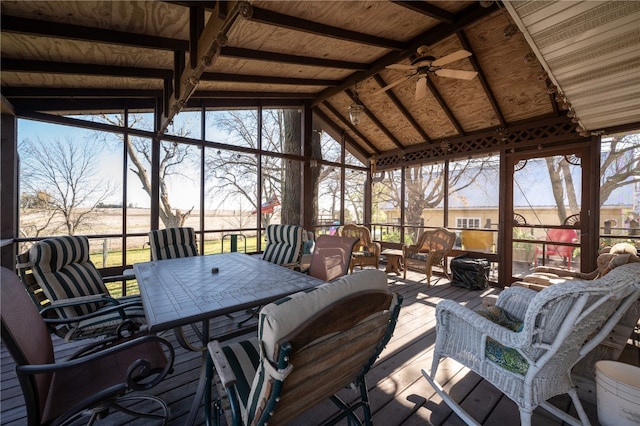 sunroom with ceiling fan and lofted ceiling with beams