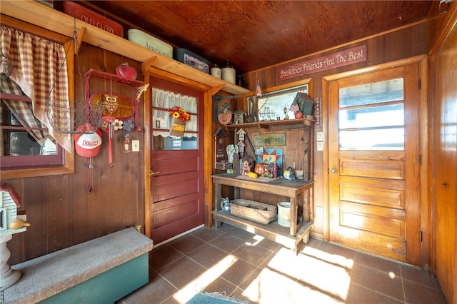 doorway with wooden walls and wood ceiling