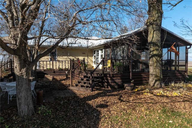 2482 65th St, Vinton, IA 52349 - view of home's exterior with a wooden deck and a sunroom