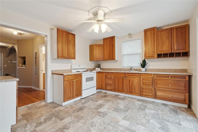 kitchen featuring sink, electric range, and ceiling fan