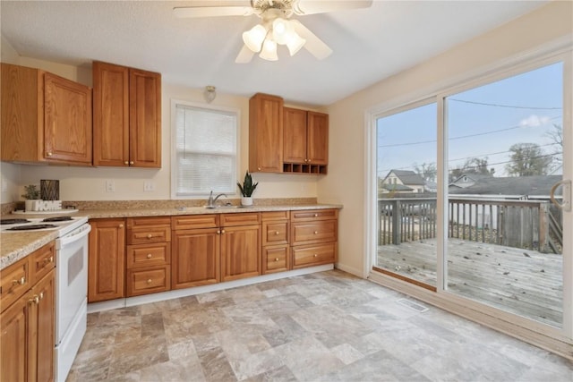 kitchen with sink, ceiling fan, and white range with electric cooktop