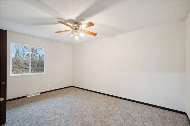 unfurnished room with carpet flooring, a textured ceiling, and ceiling fan