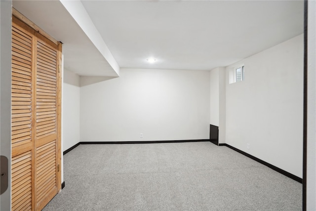 basement featuring light colored carpet