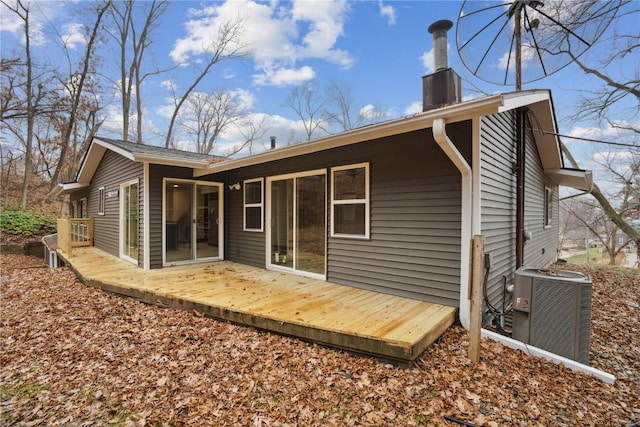 back of house featuring central AC unit and a wooden deck